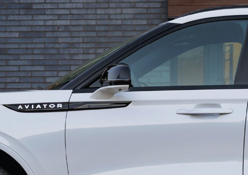 The driver’s side door and fender badging of a white 2026 Lincoln Aviator® SUV are showcased. | Palmetto Lincoln in Charleston SC