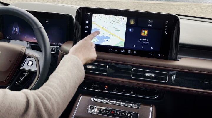 A person is tapping the center display touchscreen of a 2026 Lincoln Aviator® SUV. | Palmetto Lincoln in Charleston SC