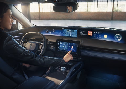 The driver of a 2026 Lincoln Nautilus® SUV interacts with the center touchscreen. | Palmetto Lincoln in Charleston SC