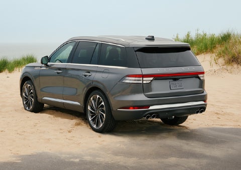 A 2027 Lincoln Aviator® SUV is parked next to sand dunes. | Palmetto Lincoln in Charleston SC
