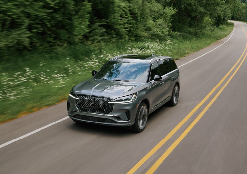 A 2027 Lincoln Aviator® SUV is being driven down a road. | Palmetto Lincoln in Charleston SC