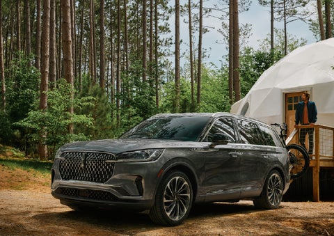 A 2027 Lincoln Aviator® is parked next to a high end glamping site. | Palmetto Lincoln in Charleston SC