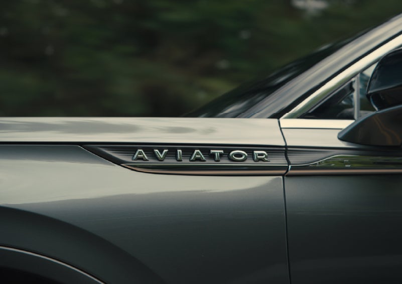 The driver’s side door and fender badging of a gray 2027 Lincoln Aviator® SUV are showcased. | Palmetto Lincoln in Charleston SC
