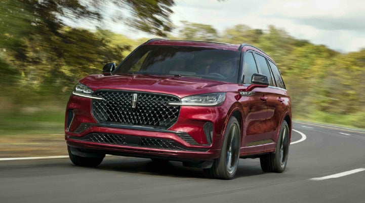 A 2027 Lincoln Aviator® SUV is being driven on a country road | Palmetto Lincoln in Charleston SC