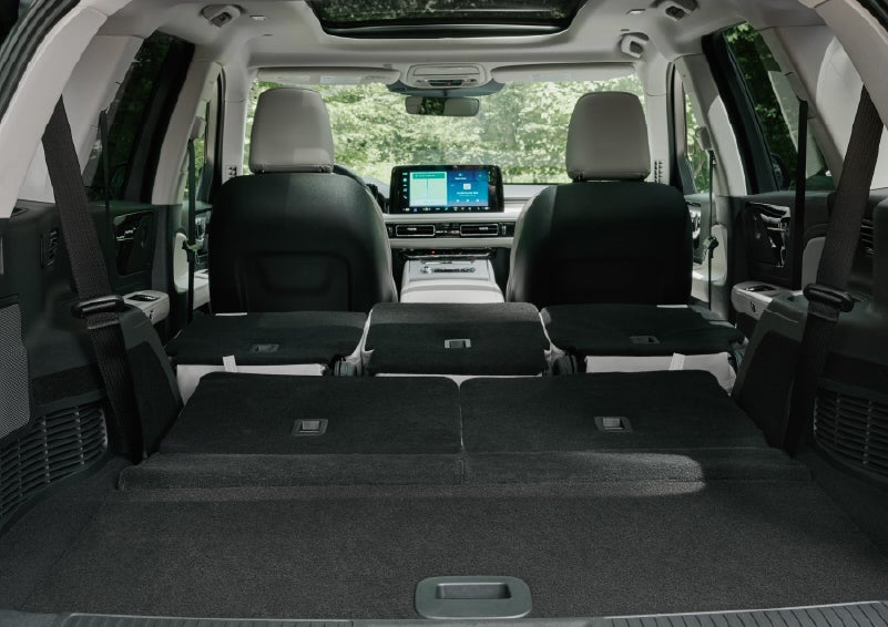 A rear to front view of the interior of a 2027 Lincoln Aviator® Black Label™ SUV shows the third and second rows folded flat | Palmetto Lincoln in Charleston SC