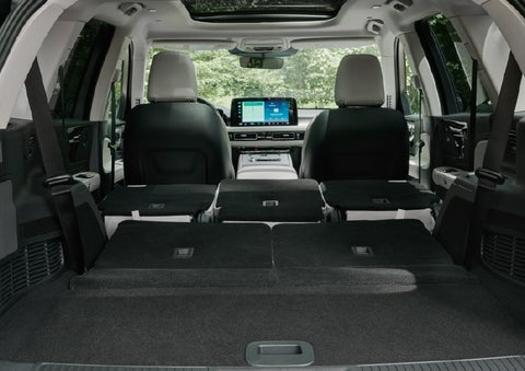 A rear to front view of the interior of a 2027 Lincoln Aviator® Black Label™ SUV shows the third and second rows folded flat | Palmetto Lincoln in Charleston SC