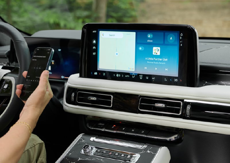 A person pairs thier phone with the center touchscreen of a 2027 Lincoln Aviator® Black Label™ SUV | Palmetto Lincoln in Charleston SC
